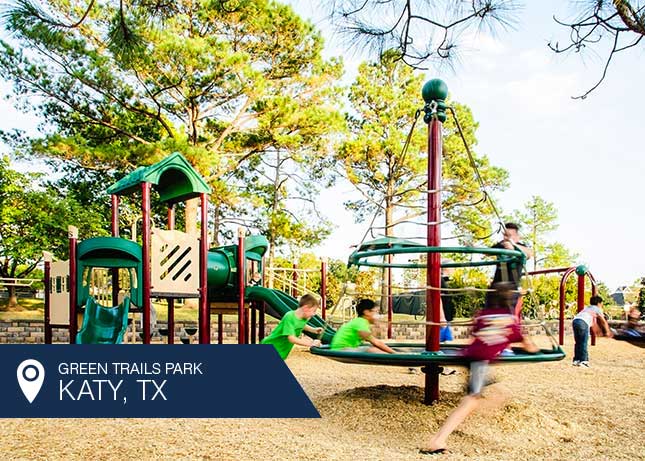 Kids playing on play structures designed and built by Kraftsman at Green Trails Park in Katy, TX