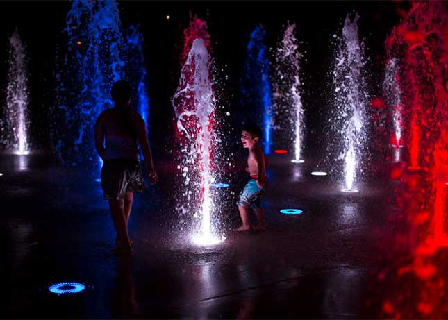 Kids playing at night in a Commercial Fountain with LED Lighting by Kraftsman