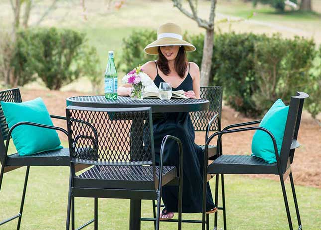Woman sitting at a park table installed by Kraftsman