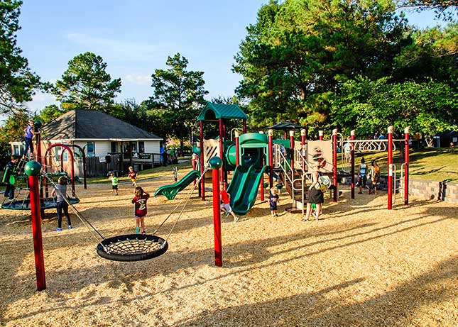Kids playing at Cypress, TX Green Trails Playground Park Design by Kraftsman