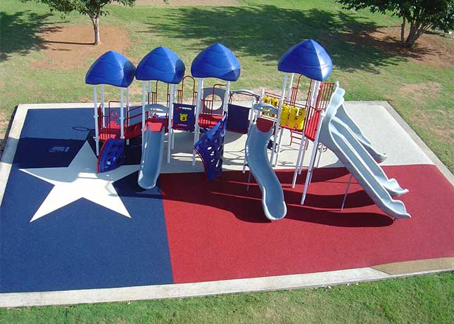 Playground installed on Safety Surfacing desgined to look like the Texas flag by Kraftsman