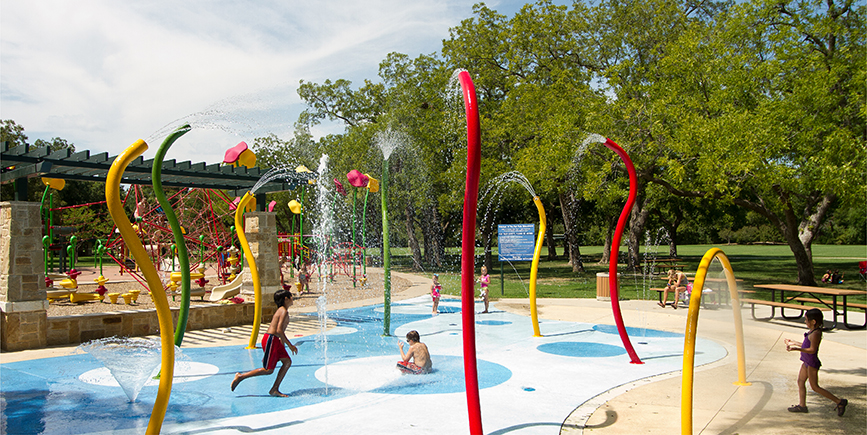 Kids playing at a Colorful Splash Park Design Build by Kraftsman