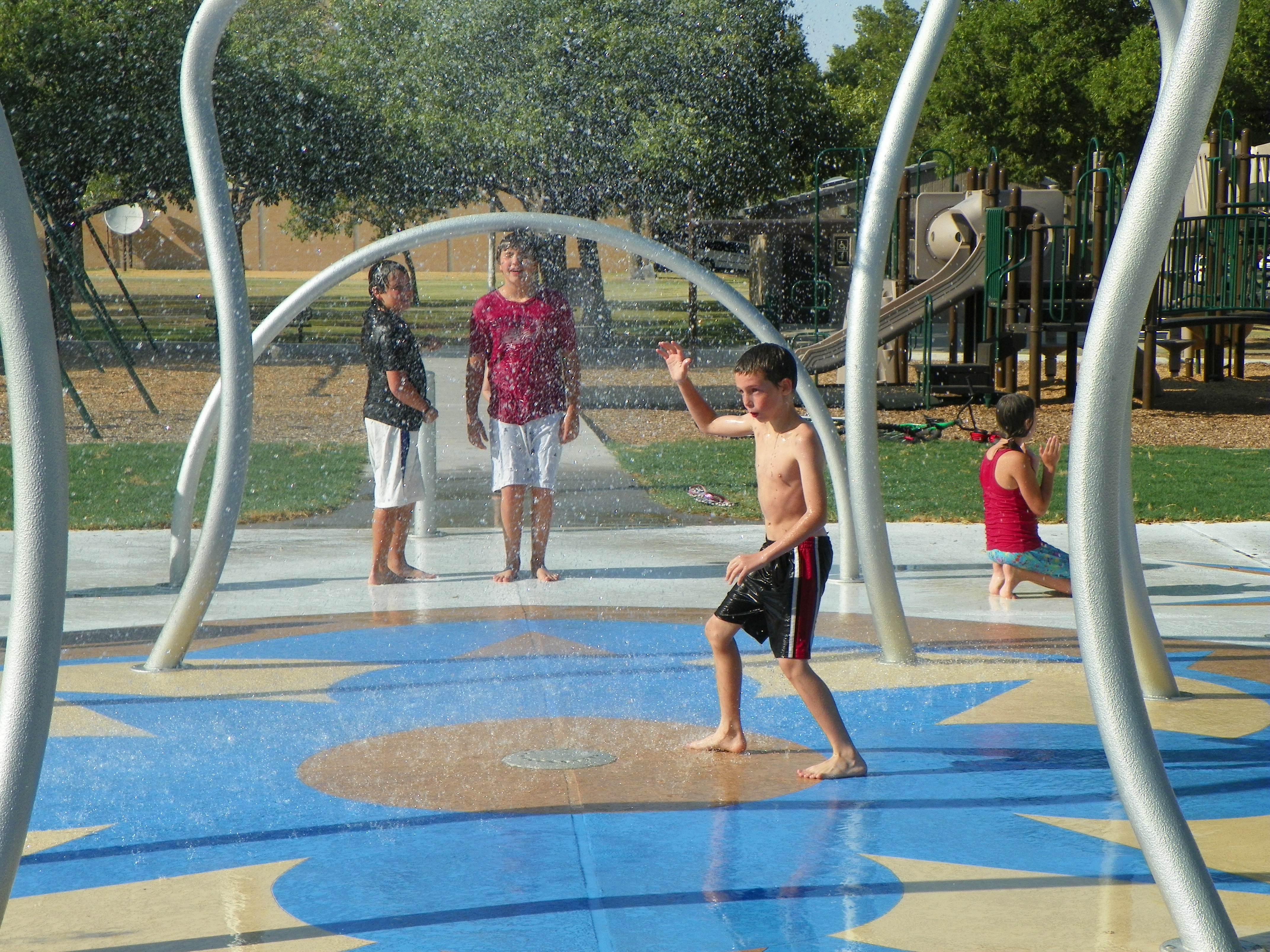 Kids playing at Amarillo, TX Memorial Park Splash Pad Design and Installation by Kraftsman