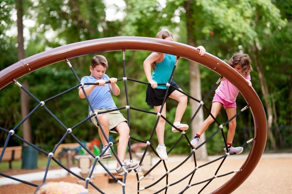 children climbing on rope structure in The Falls at Imperial Oaks
