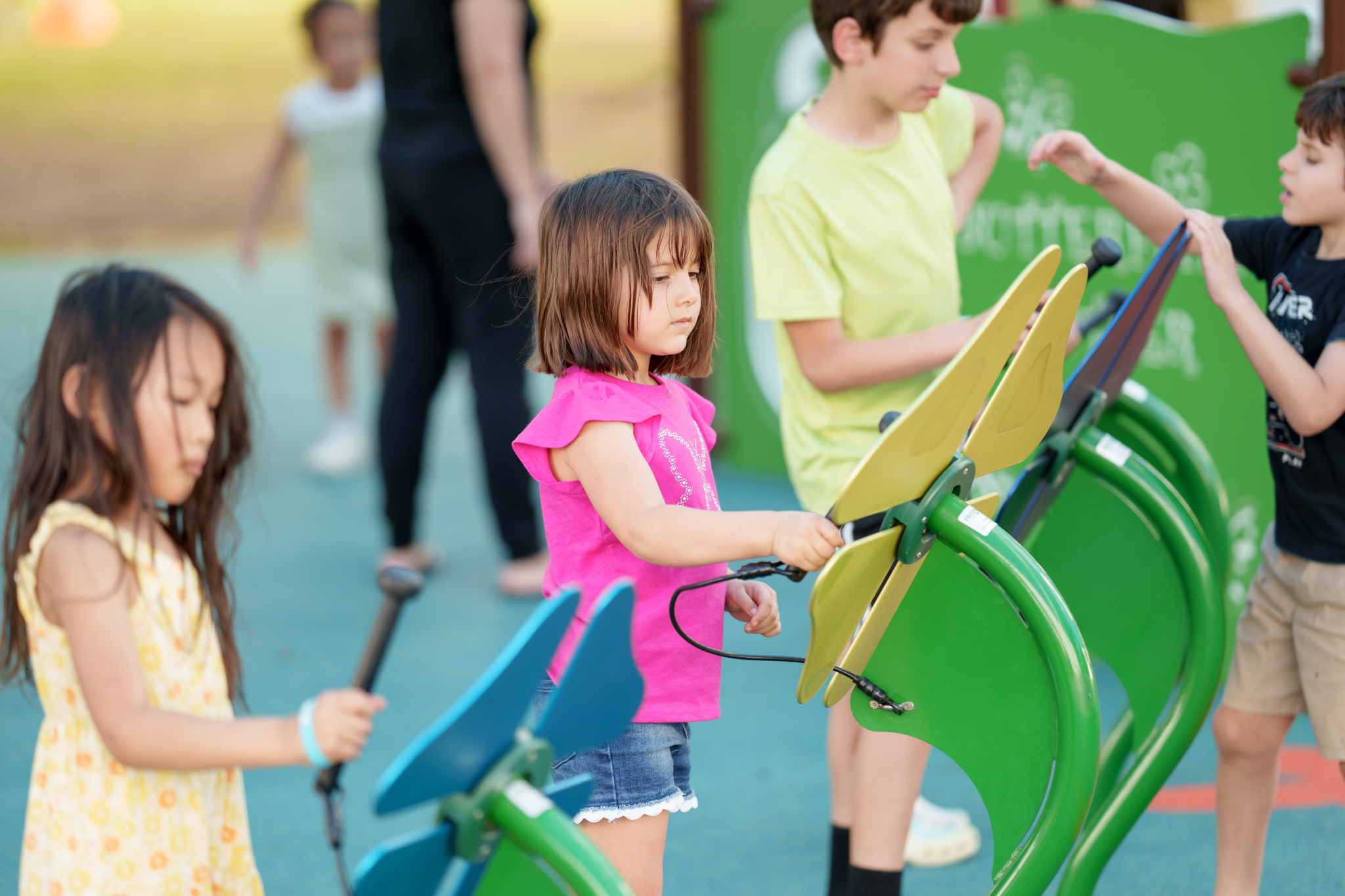 children playing on musical instruments on playground