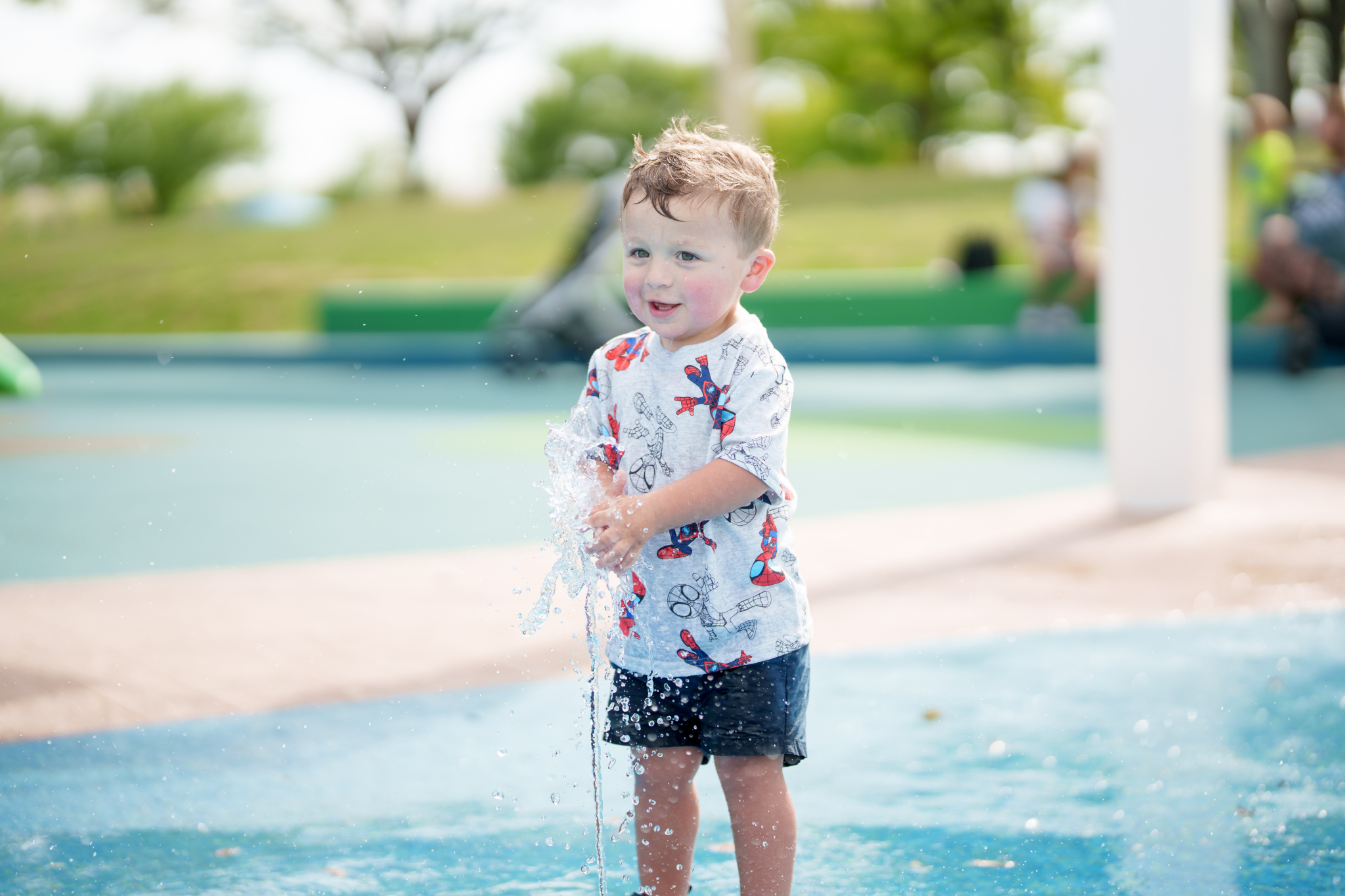 child playing on splash pad