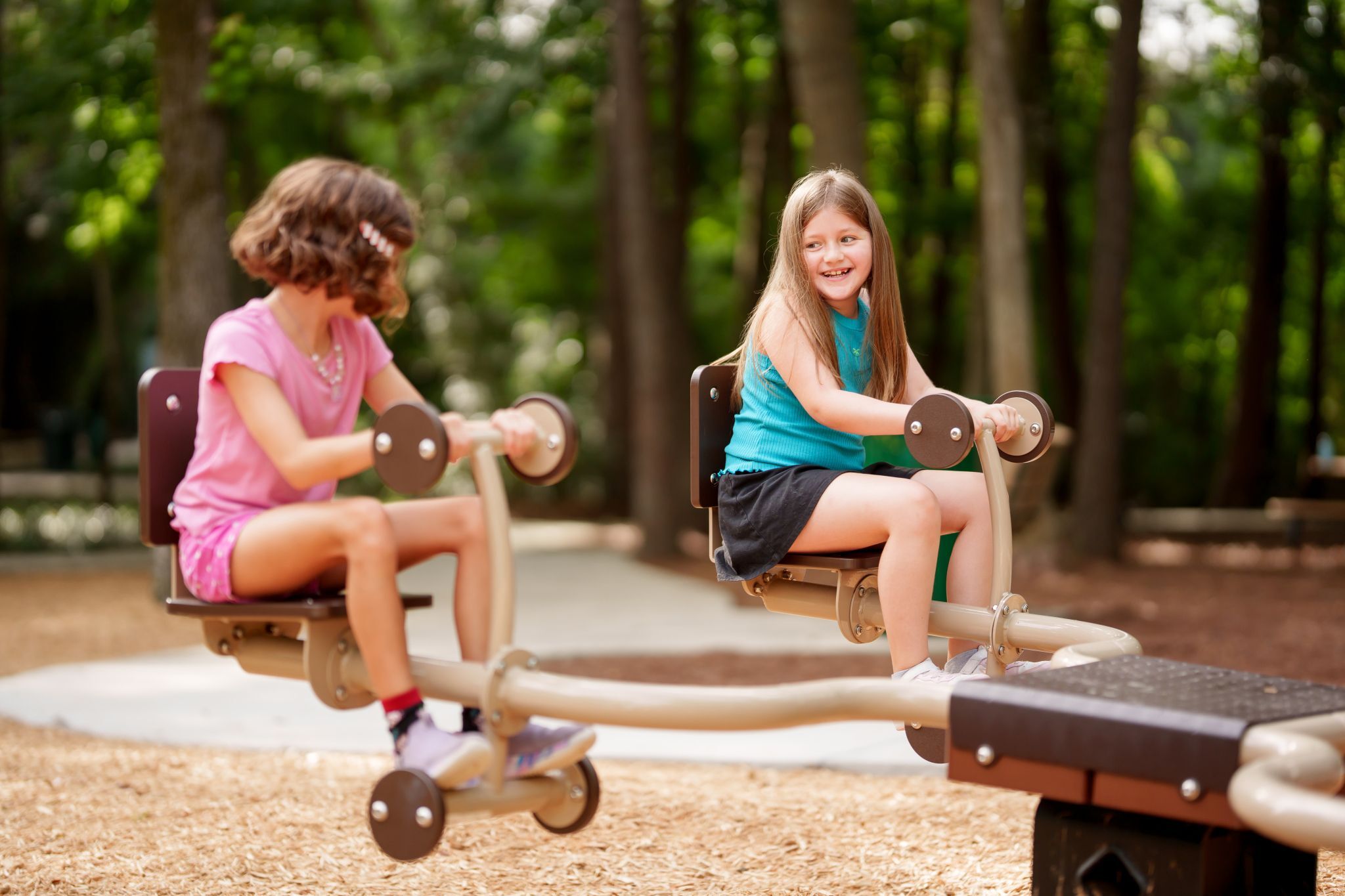 children playing on quad seesaw in The Falls at Imperial Oaks