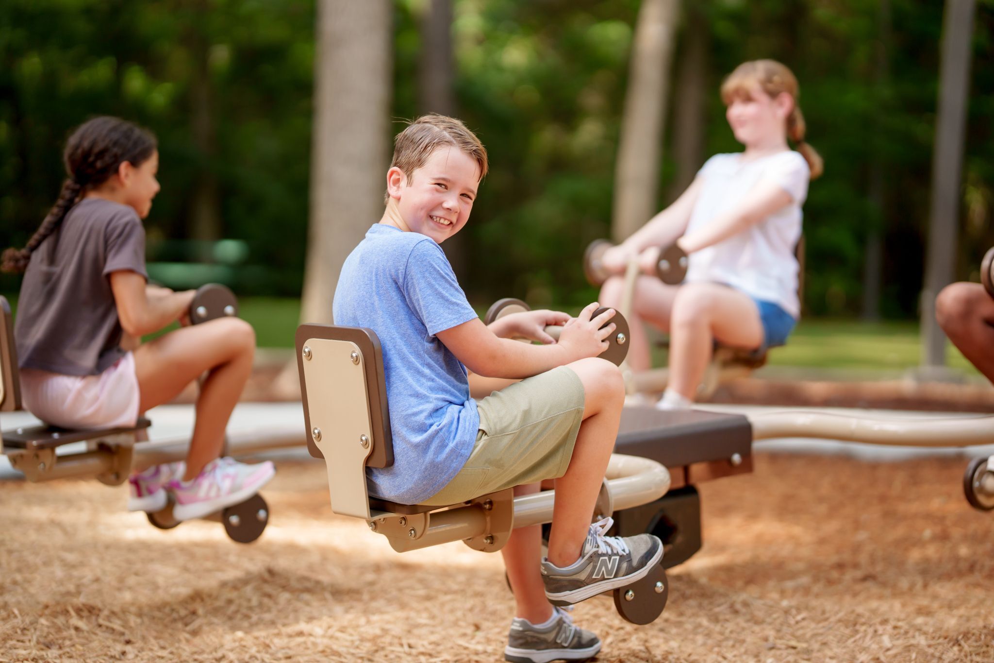 children playing on quad seesaw in The Falls at Imperial Oaks