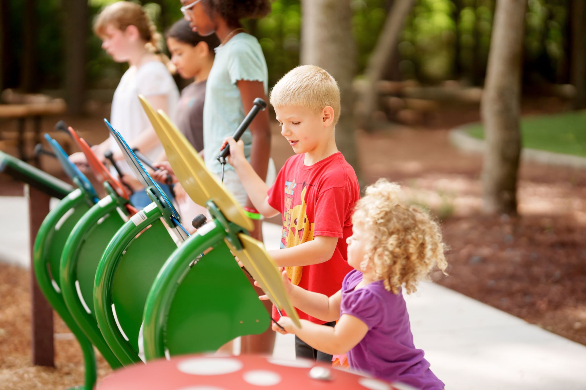 Children playing on the musical instruments in The Falls at Imperial Oaks